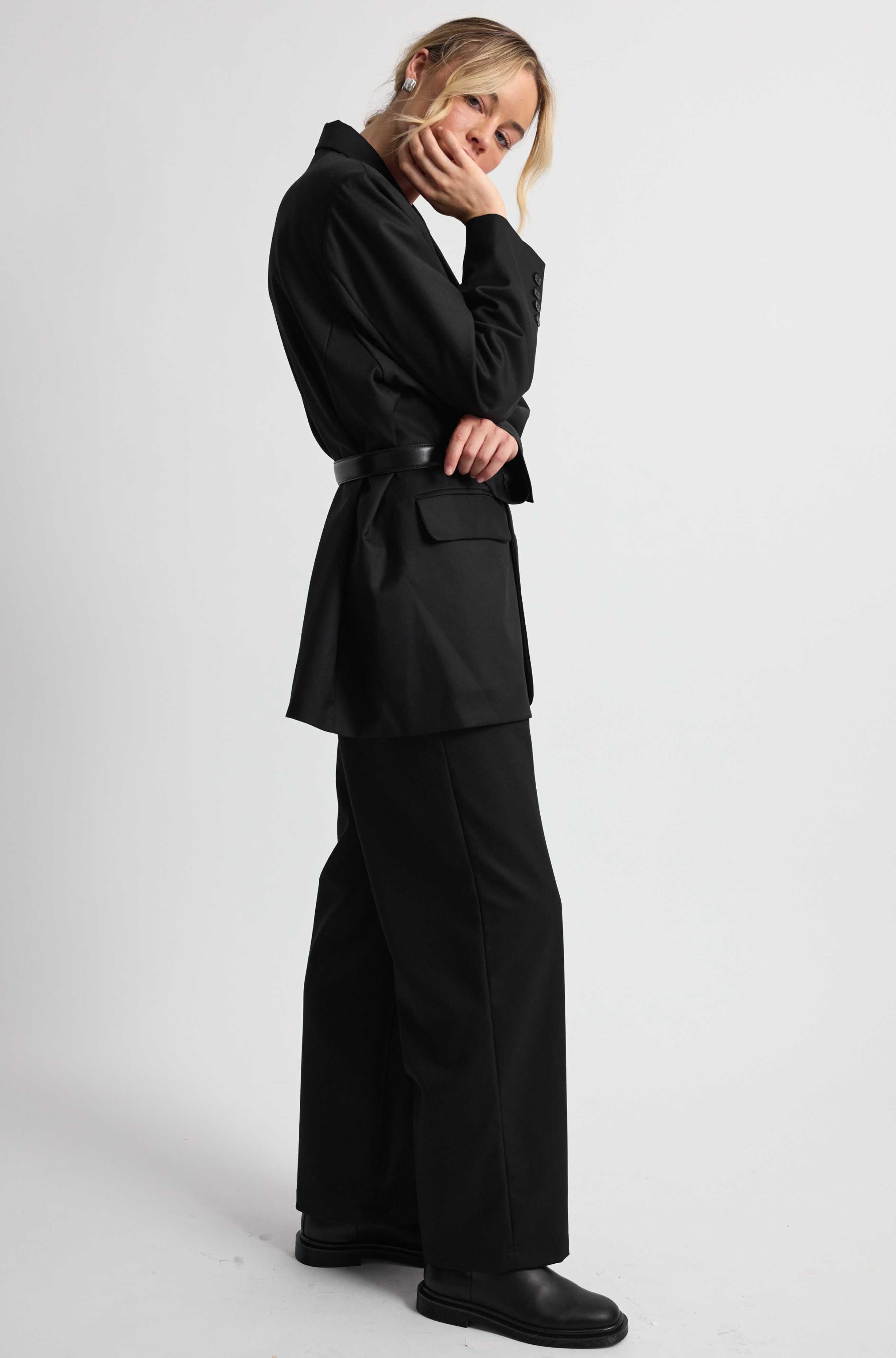 Person wearing a black outfit on a white background