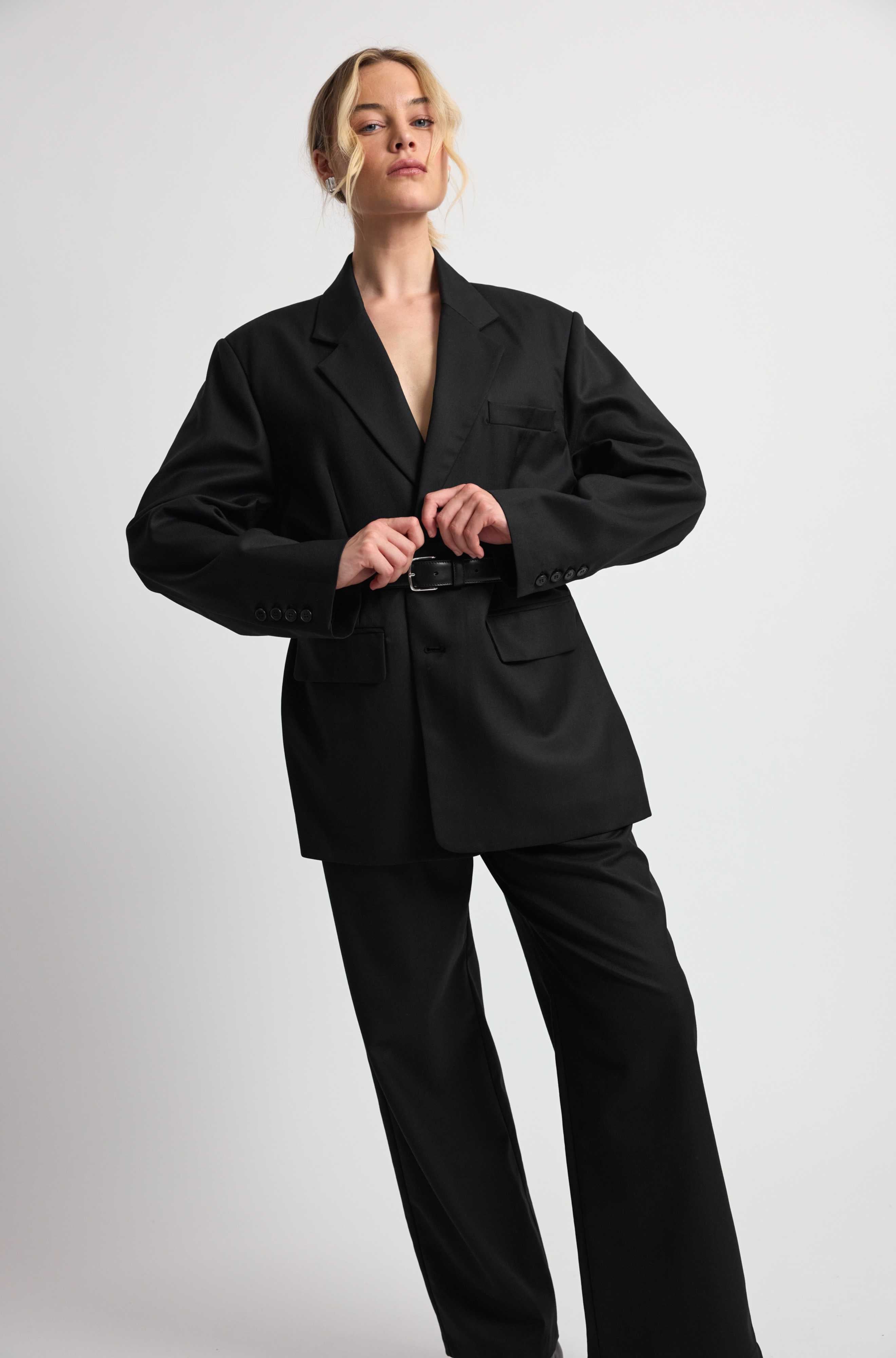 Person wearing a black suit on a white background