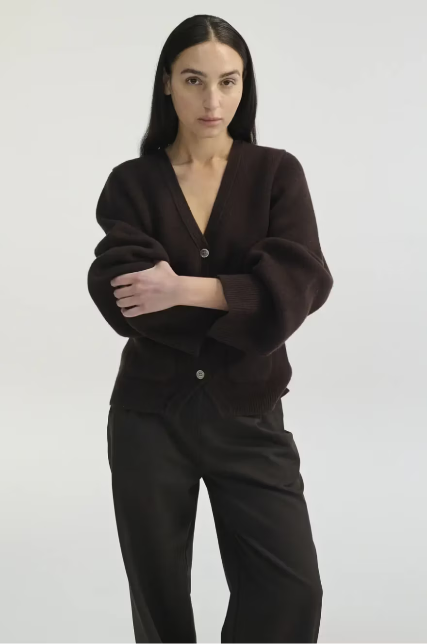 Woman wearing a brown outfit on a white background